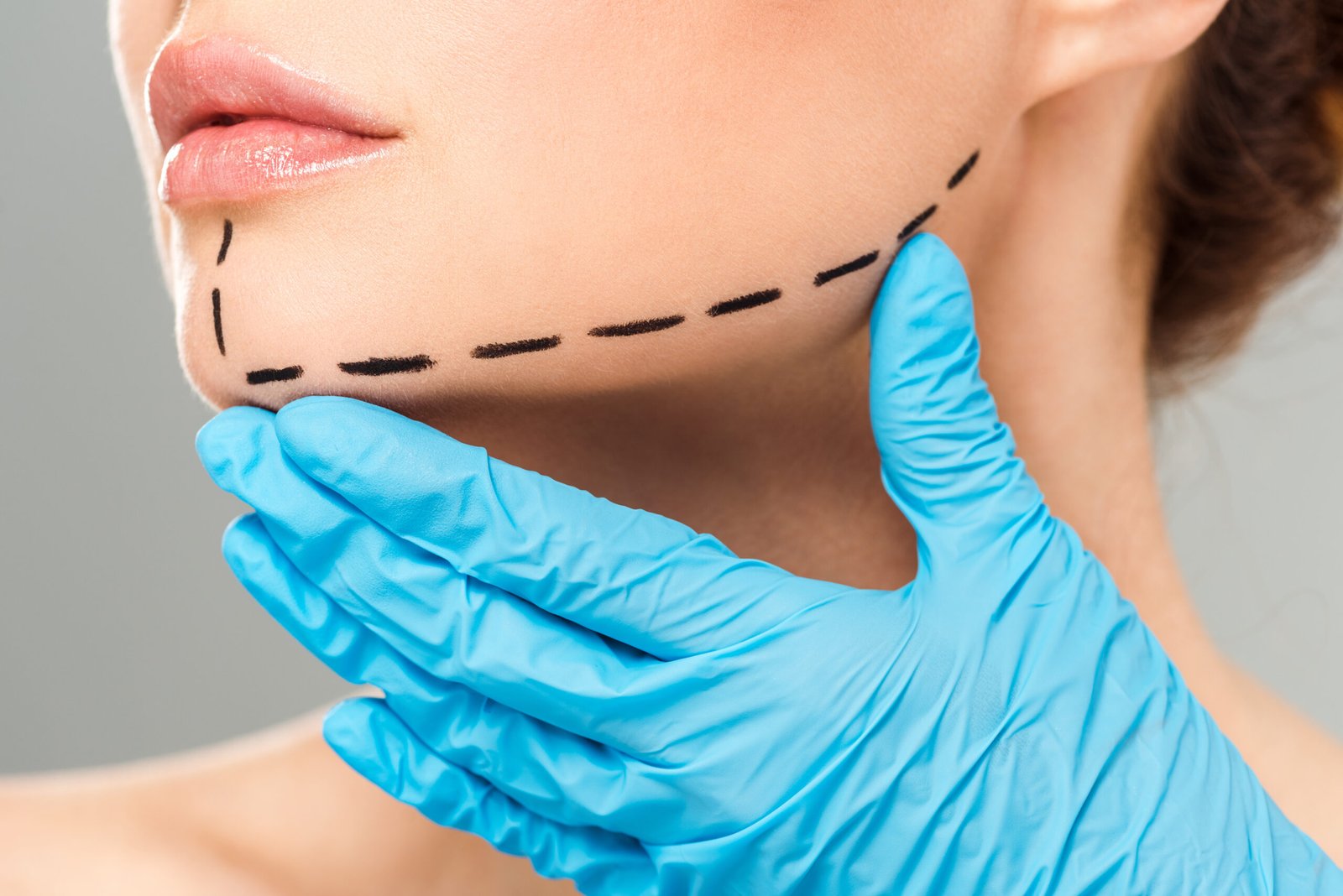 Dermatologist assessing chin structure for non-surgical contouring at Couture Dermatology