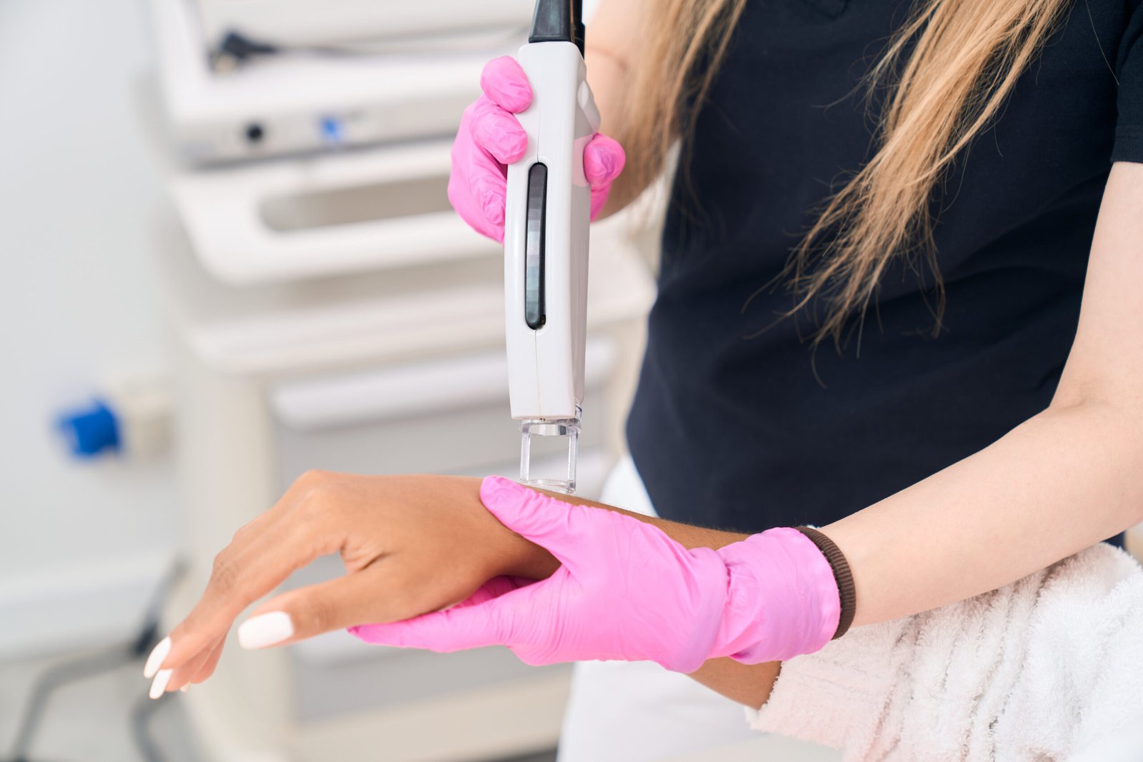 Laser treatment being performed on hands at Couture Dermatology
