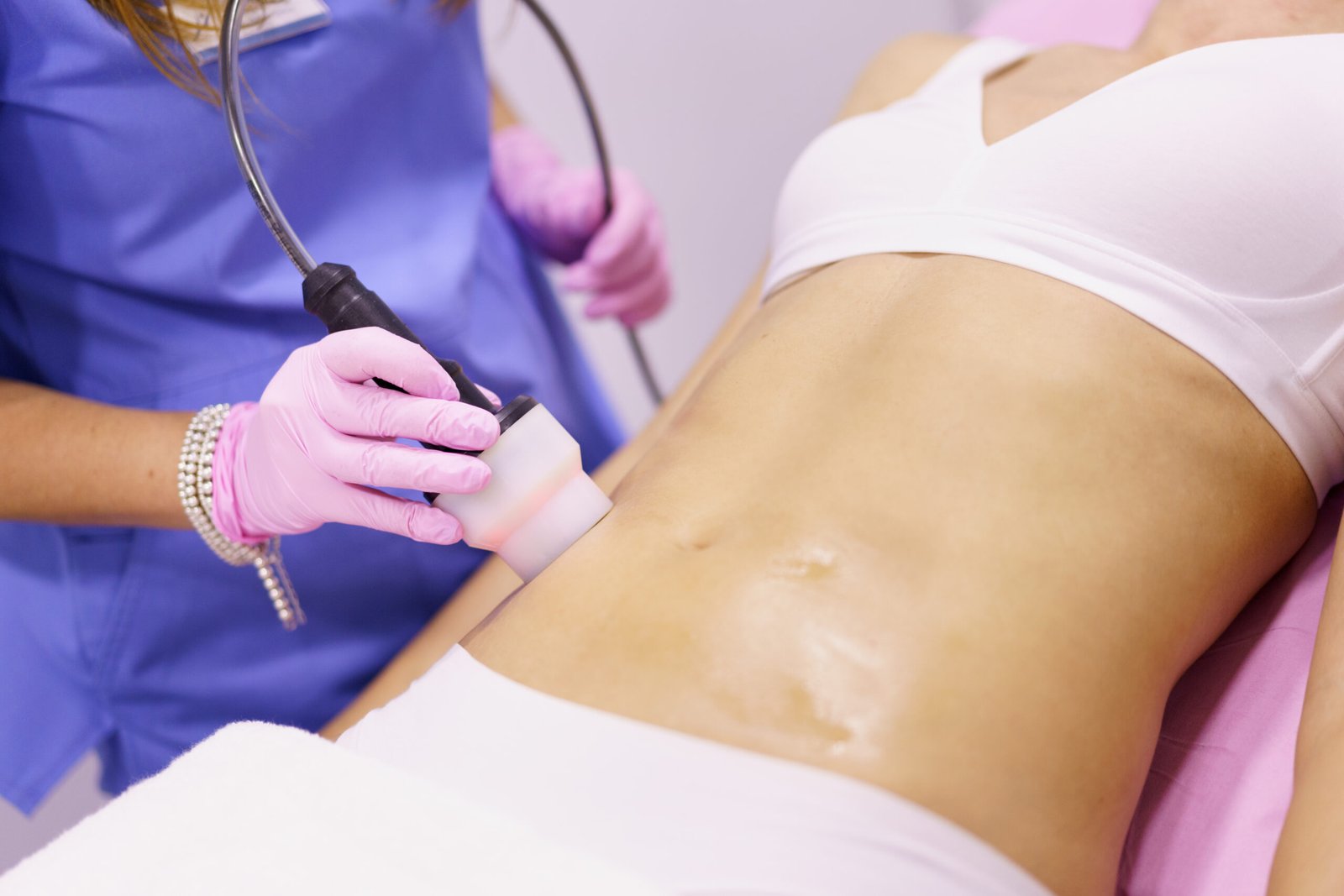 Woman receiving radiofrequency body contouring treatment at Couture Dermatology